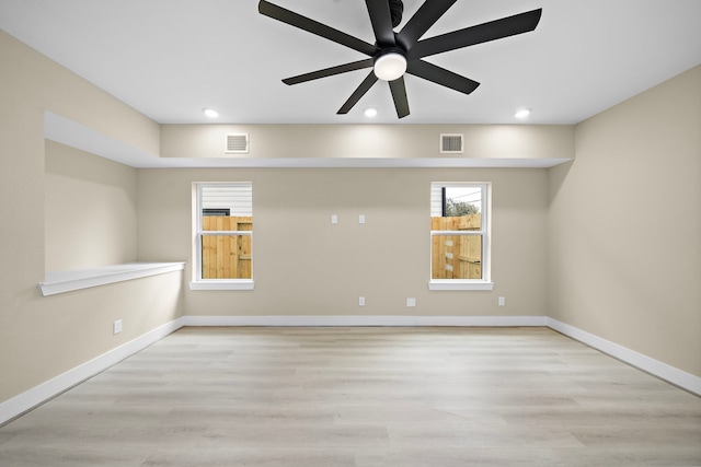 spare room featuring recessed lighting, wood finished floors, and visible vents