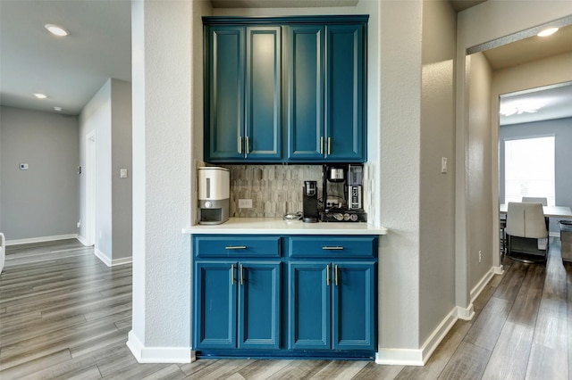 4910 Magnolia Springs Dr, Pearland, TX 77584 - bar with recessed lighting, baseboards, backsplash, and light wood-type flooring