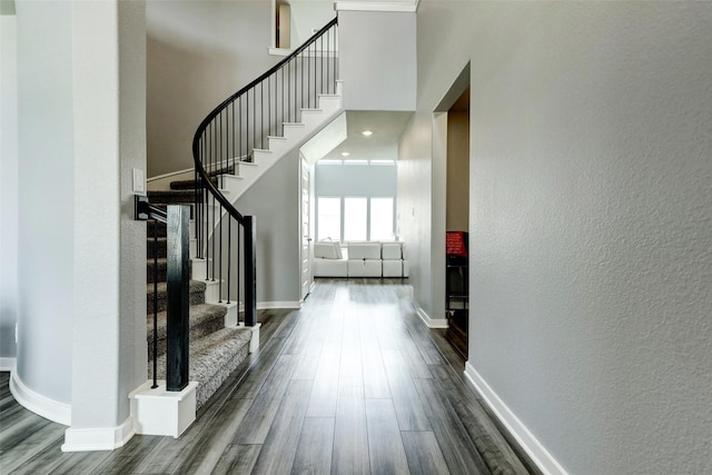 4910 Magnolia Springs Dr, Pearland, TX 77584 - interior space with dark wood-type flooring, stairs, a textured wall, and baseboards