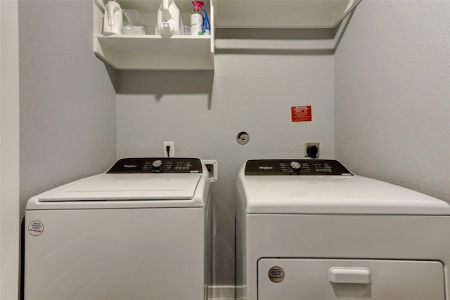 4910 Magnolia Springs Dr, Pearland, TX 77584 - clothes washing area with independent washer and dryer, laundry area, and a textured wall