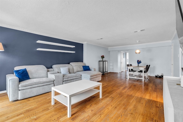 386 N Post Oak Ln, Houston, TX 77024 - living area featuring a textured ceiling, ornamental molding, and wood finished floors