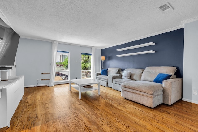 386 N Post Oak Ln, Houston, TX 77024 - living area featuring a textured ceiling, wood finished floors, crown molding, and baseboards