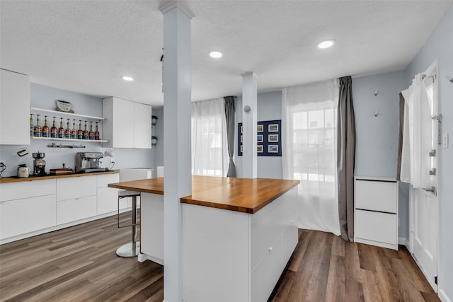 386 N Post Oak Ln, Houston, TX 77024 - kitchen featuring wooden counters, open shelves, modern cabinets, white cabinets, and a textured ceiling