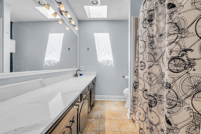 386 N Post Oak Ln, Houston, TX 77024 - full bathroom with a skylight, vanity, toilet, and baseboards