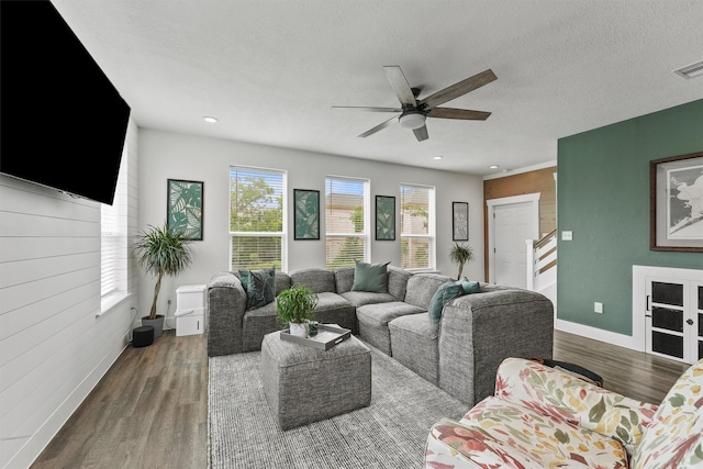 living room featuring stairs, a ceiling fan, baseboards, recessed lighting, and wood finished floors