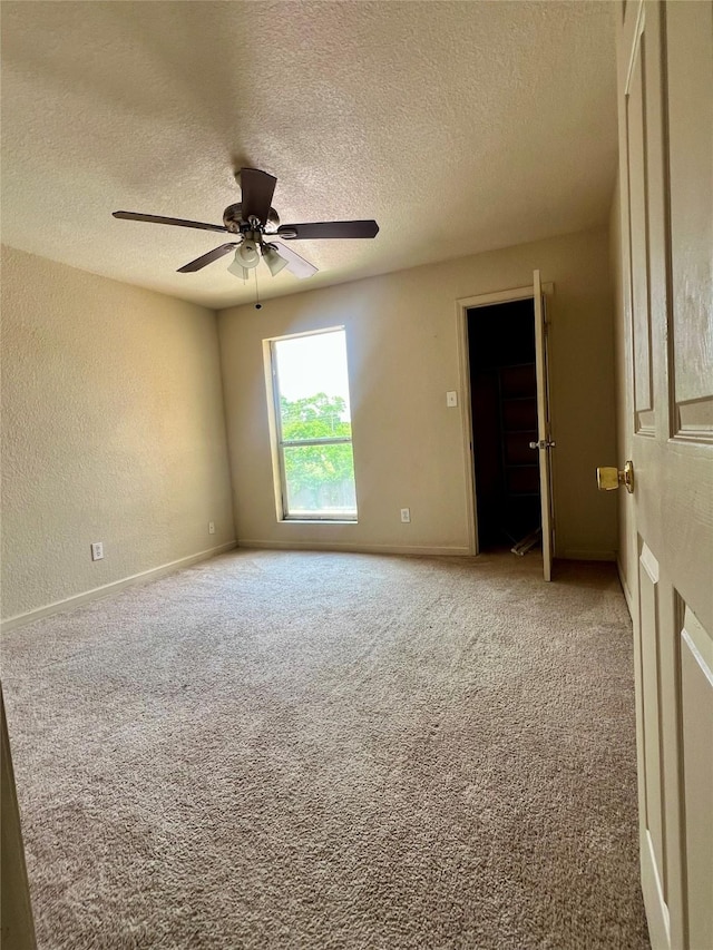 8100 Creekbend Dr Unit 117, Houston, TX 77071 - spare room with a textured ceiling, carpet floors, a ceiling fan, baseboards, and a textured wall