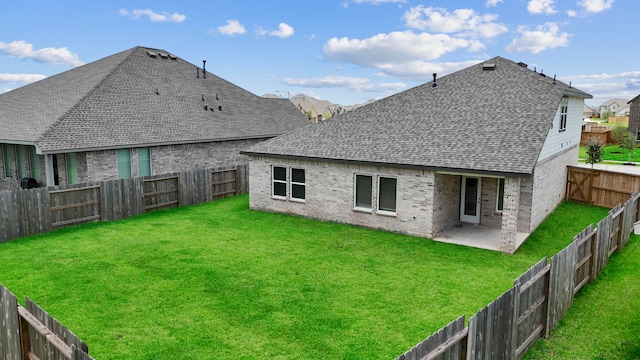 2811 Gran Castillo Dr, Texas City, TX 77568 - rear view of property featuring a shingled roof, brick siding, a fenced backyard, and a patio