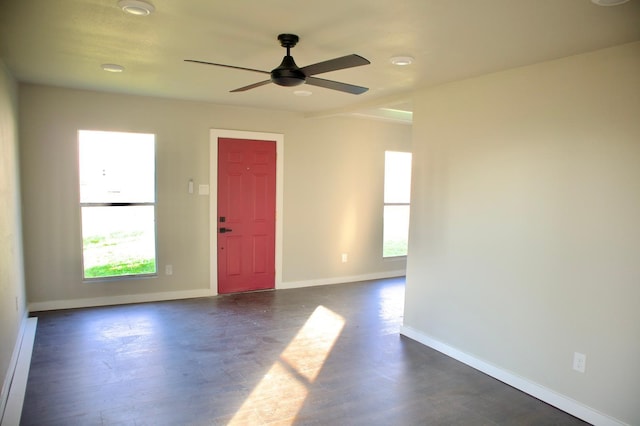 unfurnished room with ceiling fan, dark wood-style floors, and baseboards