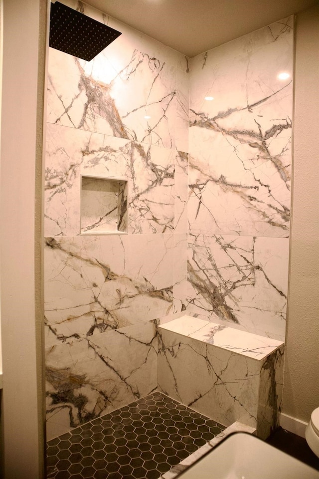 bathroom featuring walk in shower and toilet