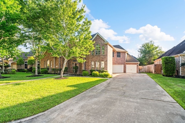 view of front of home with concrete driveway, brick siding, fence, and a front yard