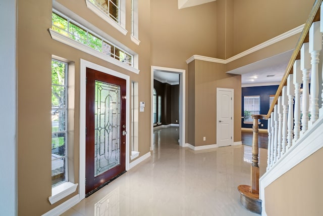 entryway featuring stairway, baseboards, and a high ceiling
