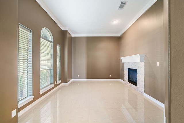 unfurnished living room featuring visible vents, ornamental molding, a healthy amount of sunlight, and a fireplace