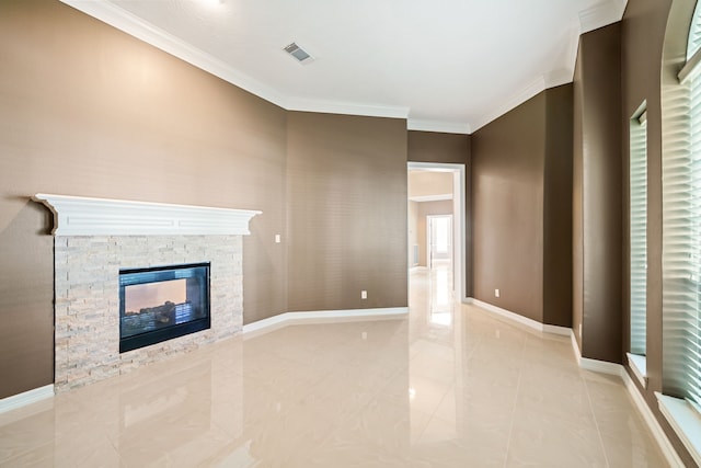 unfurnished living room with baseboards, ornamental molding, a fireplace, and visible vents