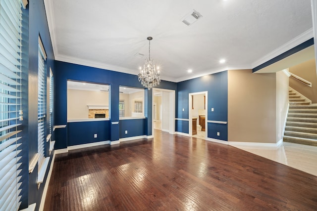 empty room with an inviting chandelier, visible vents, stairs, wood-type flooring, and recessed lighting