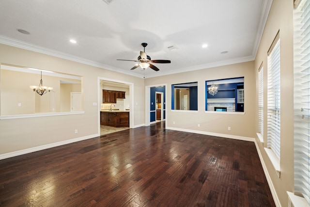 unfurnished living room featuring ornamental molding, a sink, ceiling fan with notable chandelier, and dark wood-type flooring