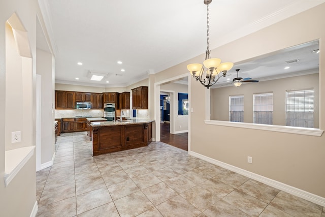 kitchen with crown molding, open floor plan, appliances with stainless steel finishes, and a wealth of natural light
