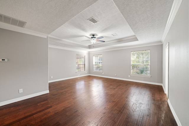 empty room with dark wood-style flooring, a ceiling fan, visible vents, and a wealth of natural light