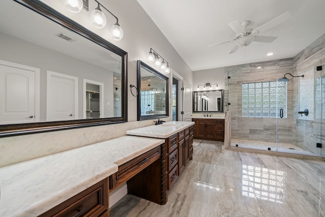bathroom with a healthy amount of sunlight, vanity, a shower stall, and visible vents