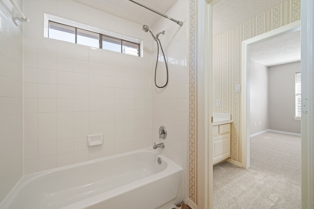 bathroom with baseboards, vanity, tub / shower combination, and wallpapered walls