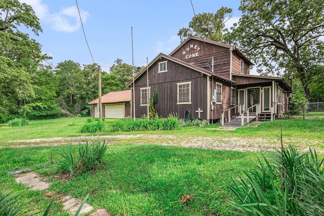 189 Lake Livingston Blvd, Livingston, TX 77351 - exterior space featuring a detached garage, fence, and a front lawn