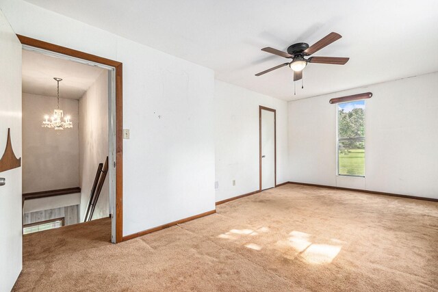 189 Lake Livingston Blvd, Livingston, TX 77351 - carpeted empty room featuring baseboards and ceiling fan with notable chandelier