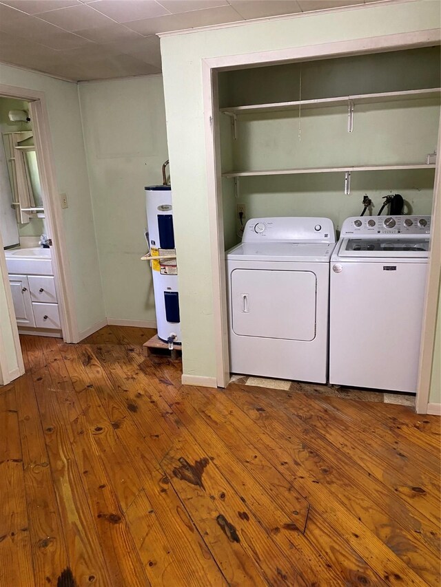 189 Lake Livingston Blvd, Livingston, TX 77351 - laundry room with independent washer and dryer, laundry area, a sink, wood-type flooring, and water heater