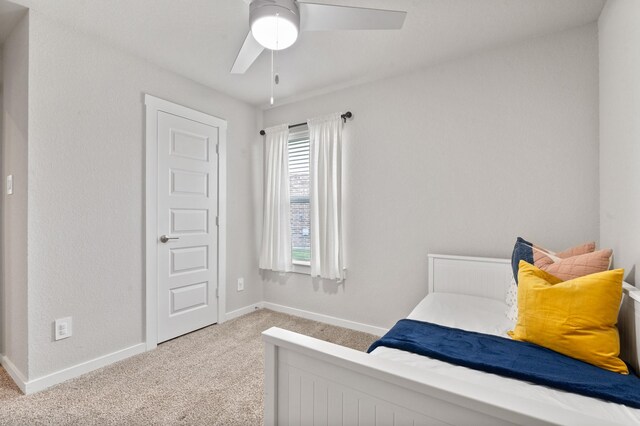 carpeted bedroom with baseboards and ceiling fan