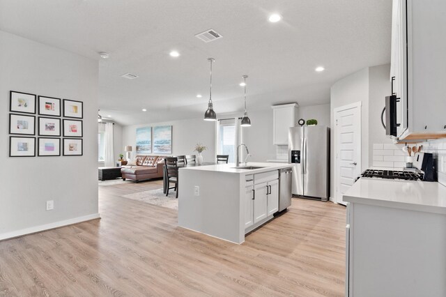 kitchen featuring appliances with stainless steel finishes, backsplash, recessed lighting, and visible vents
