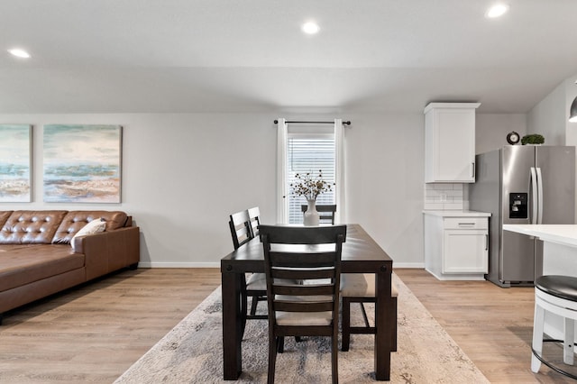 dining area with light wood-style floors, recessed lighting, and baseboards