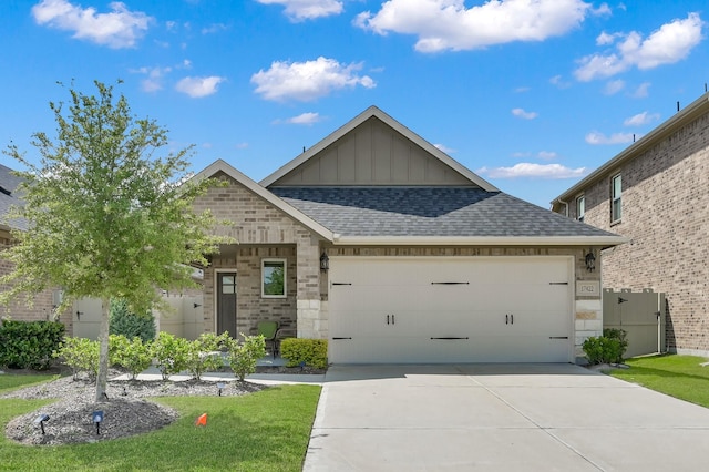 17422 Buckeye Br, Conroe, TX 77385 - view of front of home featuring board and batten siding, an attached garage, roof with shingles, driveway, and a front lawn