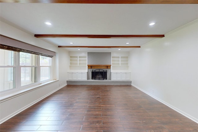 unfurnished living room with ornamental molding, beam ceiling, dark wood-style floors, and a fireplace