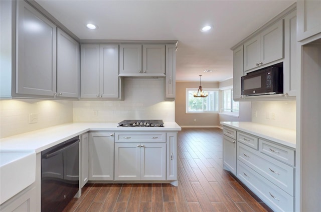 kitchen featuring light countertops, gray cabinets, black appliances, and dark wood-style flooring