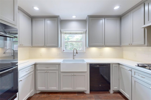 kitchen featuring gray cabinets, a sink, double oven, and dishwasher