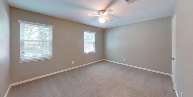 unfurnished room featuring ceiling fan, visible vents, baseboards, and carpet
