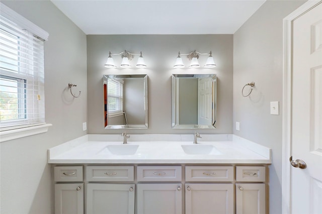 bathroom featuring a sink and double vanity