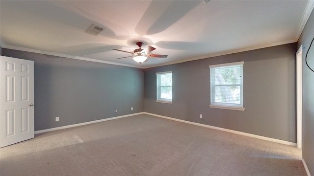 unfurnished bedroom featuring crown molding, ceiling fan, carpet, baseboards, and visible vents