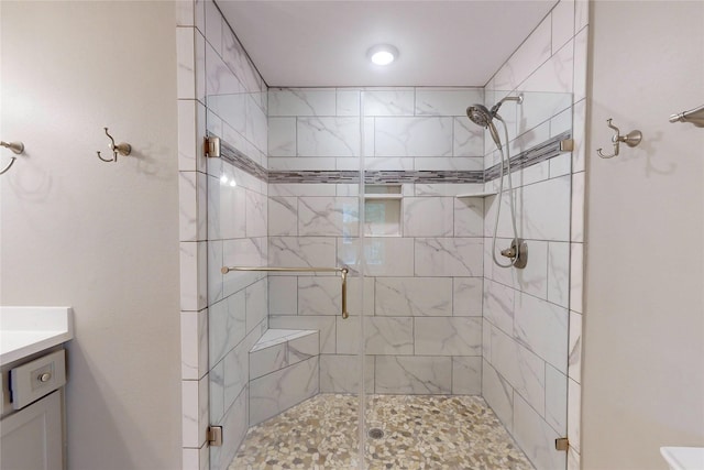 bathroom featuring a shower stall and vanity