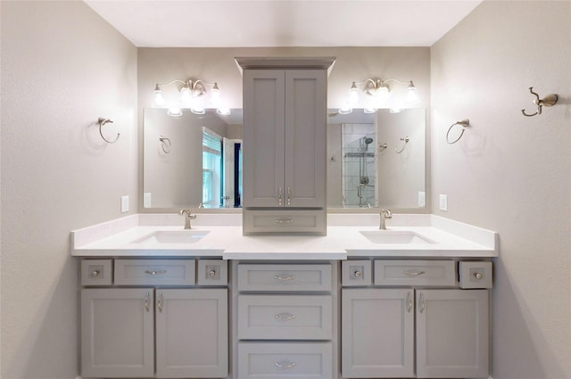 full bathroom featuring double vanity, a sink, and a stall shower