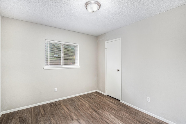 12719 Panay Dr, Houston, TX 77048 - spare room featuring baseboards, a textured ceiling, and wood finished floors