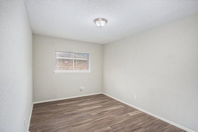 12719 Panay Dr, Houston, TX 77048 - empty room with baseboards, a textured ceiling, and dark wood-style floors