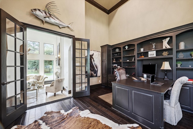 office featuring a high ceiling, ornamental molding, french doors, baseboards, and dark wood-style floors