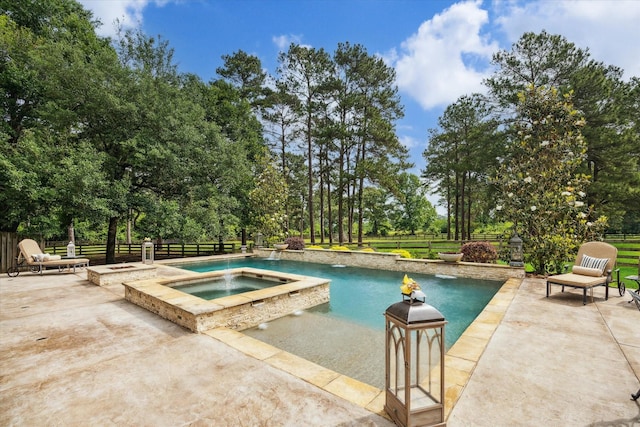 outdoor pool with fence, an in ground hot tub, and a patio area