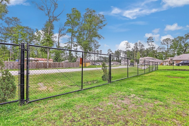 view of yard featuring fence and a gate