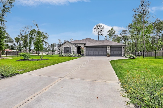 view of front of home with concrete driveway, an attached garage, fence, and a front lawn