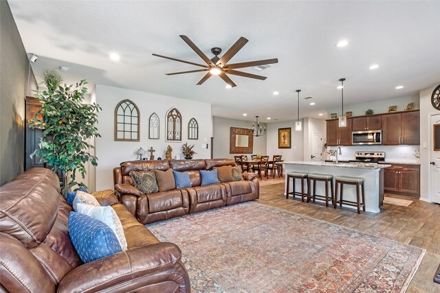 living room with recessed lighting, ceiling fan, visible vents, and wood finished floors