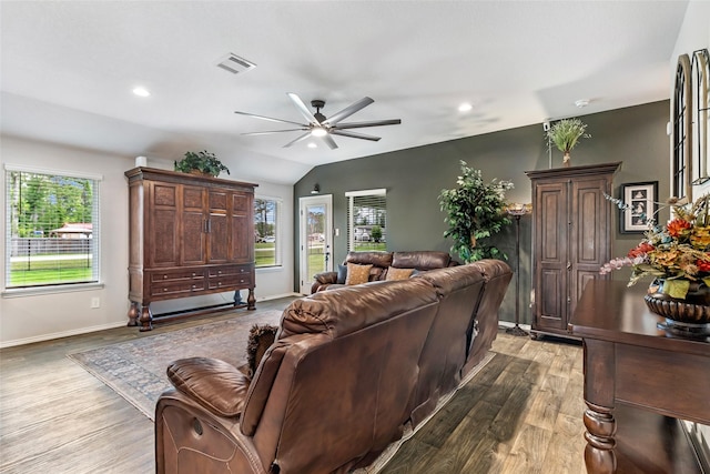 living room with visible vents, a ceiling fan, plenty of natural light, and wood finished floors