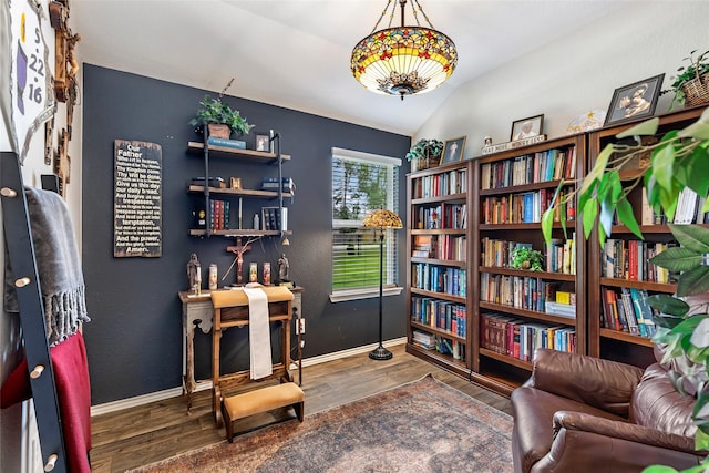 sitting room with baseboards, lofted ceiling, and wood finished floors