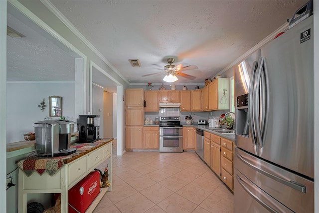 kitchen featuring under cabinet range hood, crown molding, appliances with stainless steel finishes, and a sink