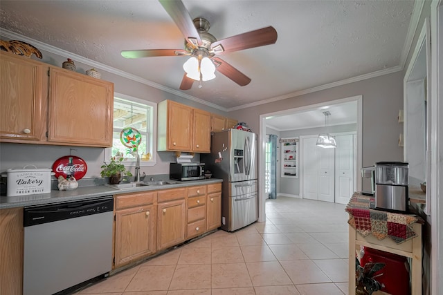 kitchen featuring a ceiling fan, crown molding, appliances with stainless steel finishes, a sink, and light tile patterned flooring