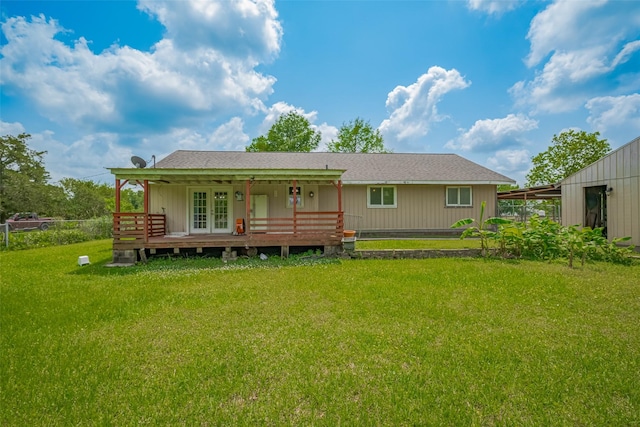 rear view of property with a lawn, french doors, and a wooden deck